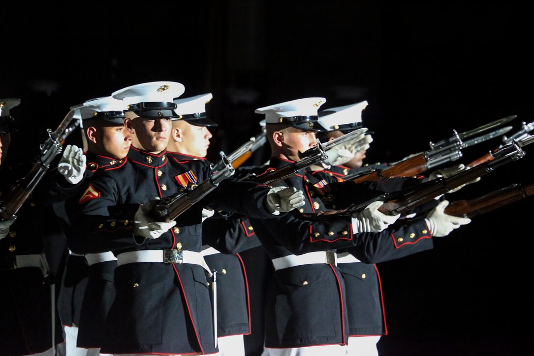 Marines with the U.S. Marine Corps Silent Drill Platoon execute their “bursting bomb” sequence during the Staff Non-Commissioned Officer Friday Evening Parade at Marine Barracks Washington D.C., July 26, 2019. The hosting official for the evening was Sgt. Maj. Ronald L. Green, 18th Sergeant Major of the Marine Corps, and Troy E. Black, 19th Sergeant Major of the Marine Corps, was the guest of honor. (U.S. Marine Corps photo by Cpl. James Bourgeois)