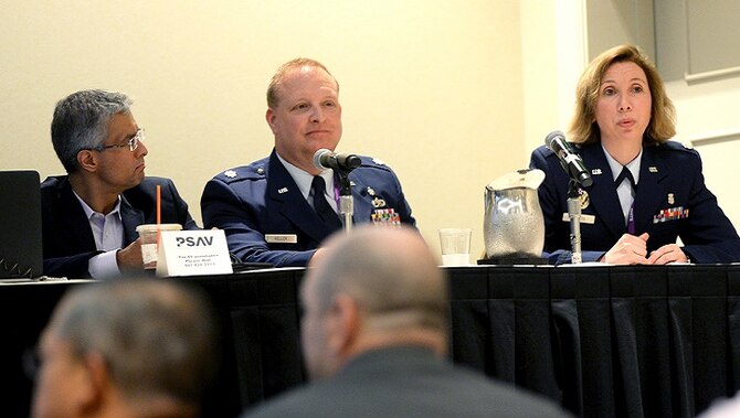 Saad Khan, (left), DHA's chief of biomedical devices integration listens to Air Force Lt. Col. Christina Sheets (right), the assistant program manager for MHS GENESIS Baseline. Khan explained that across five clinical capabilities – anesthesia, laboratory, PACS (picture archiving and communications system), pharmacy, and physiological monitoring – 17,359 individual medical devices are currently connected to legacy electronic health records. (MHS photo)