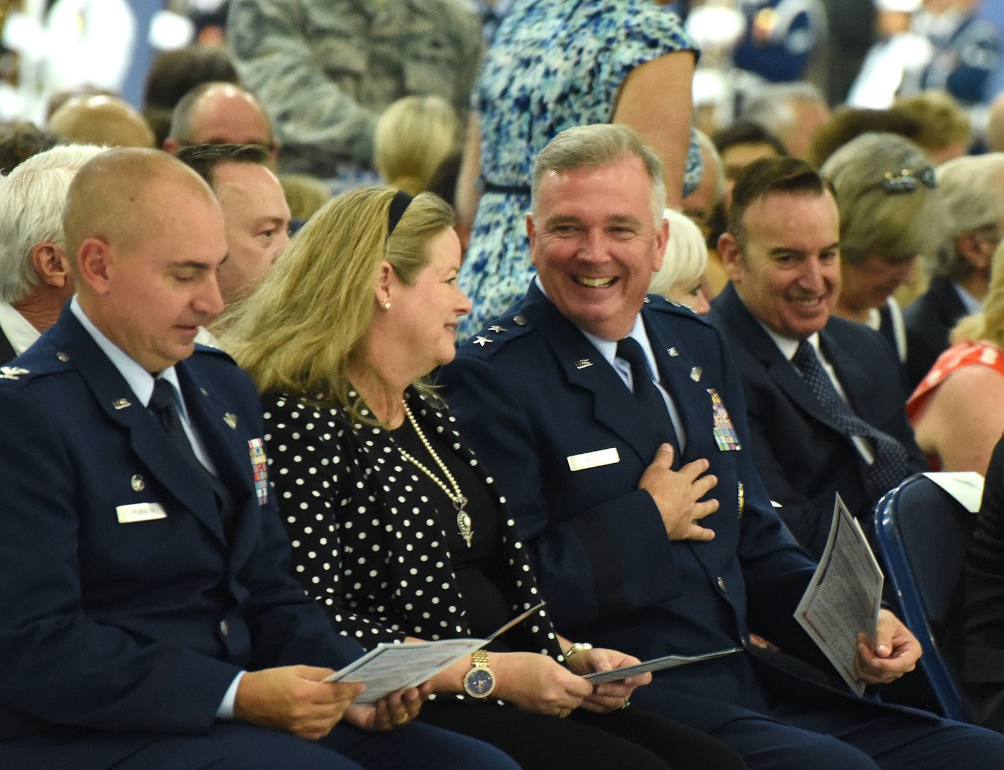 Col. Andrew M. Purath, 11th Wing and Joint Base Andrews commander, peruses a program as Charlotte Rupp and her husband, Air Force District of Washington Commander Maj. Gen. Ricky N. Rupp share a candid moment before the retirement ceremony in honor of United States Air Force Gen. Paul J. Selva, Vice Chairman of the Joint Chiefs of Staff. Selva, the 10th Vice Chairman of The Joint Staff, retires from the Air Force after more than 39 years of honorable service. (U.S. Air Force photo/Master Sgt. Amaani Lyle) — at Joint Base Andrews.