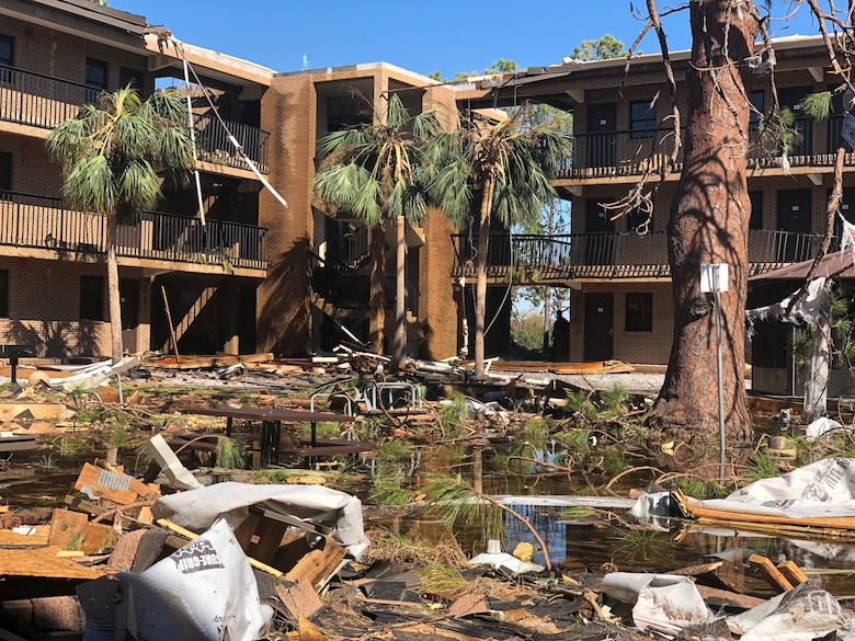 The courtyard of a student housing complex at Tyndall Air Force Base, Florida, sits flooded with water and debris following Hurricane Michael on October 10, 2018. AFIMSC employed a cash-flow strategy for recovery efforts at Tyndall, and in response to March 2019 flooding at Offutt AFB, Nebraska, and following an earthquake at Joint Base Elmendorf-Richardson, Alaska, in November 2018. (U.S. Army photo by Staff Sgt. Alexander Henninger)