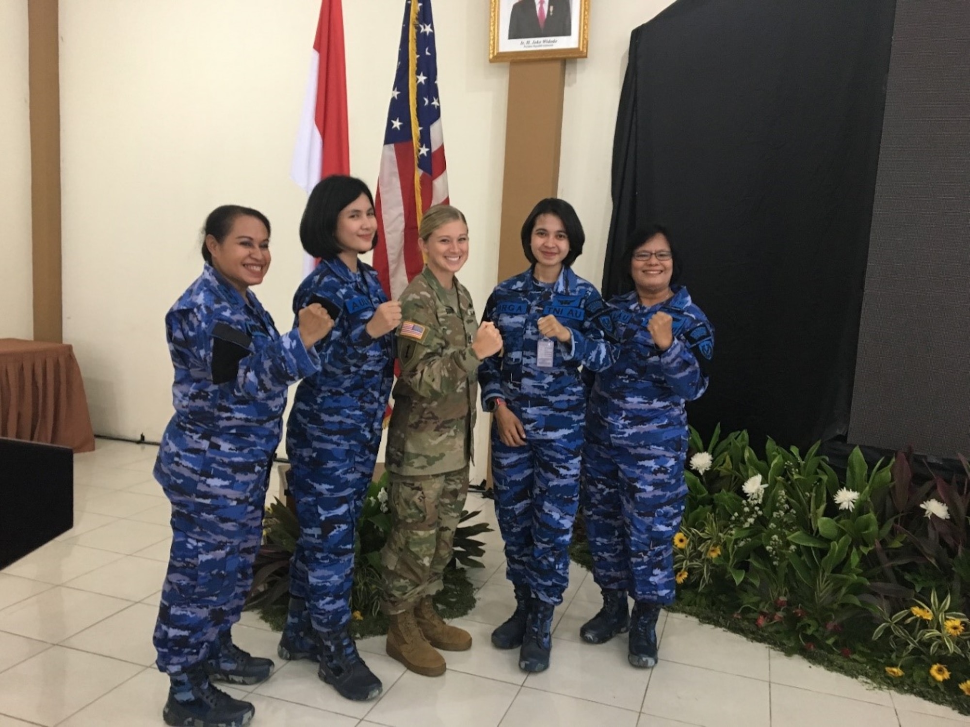 U.S. Army Pacific Capt. Lacey Sovern, Apache pilot, Assistant Operations Officer, 25th Combat Aviation Brigade, takes a group photo with Indonesian Air Force doctors and nurses. (Courtesy Photo)