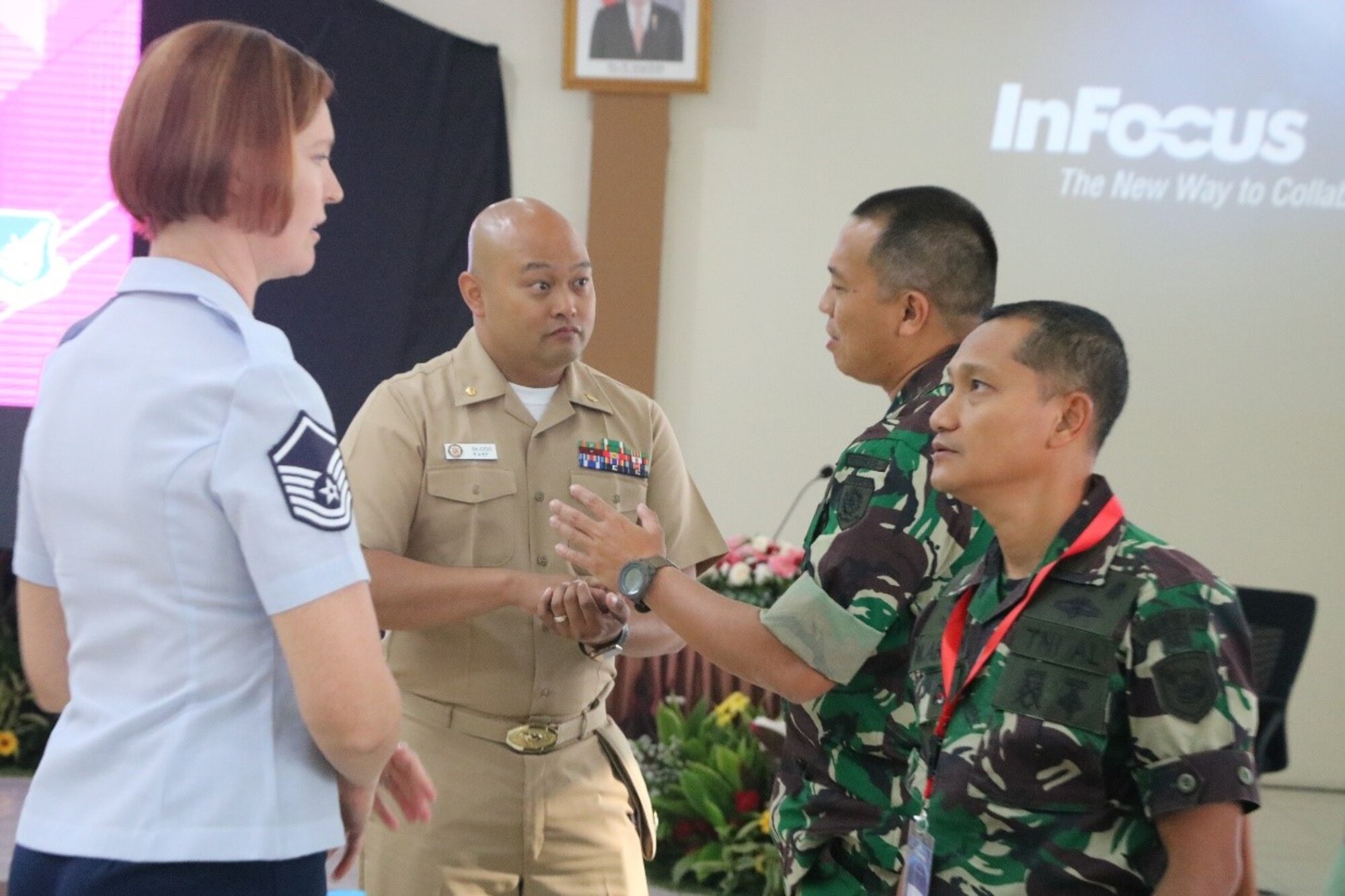 U.S. Air Force Master Sgt. Susanna Rogers, 18th Aeromedical Evacuation Squadron flight chief from Kadena Air Base, Japan, and U.S. Navy Lt. Cmdr. Ramir Salcedo, Operations Officer, 1st Medical Battalion, Camp Pendleton, California with the Indonesian National Armed Forces Army and Marine Medical Battalion Commanders during day two Humanitarian Assistance Disaster Relief tabletop exercise. (Courtesy Photo)