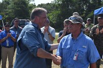 James Geurts (left), assistant secretary of the Navy for research, development and acquisition, congratulates Rod Peterson on a successful Advanced Naval Technology Exercise (ANTX) East in Camp Lejeune, N.C., on July 18, 2019. Peterson is the Marine Corps Vulnerability and Protection Program manager at Naval Surface Warfare Center, Carderock Division and was the technical lead for ANTX East. (U.S. Navy photo by Kelley Stirling/Released)
