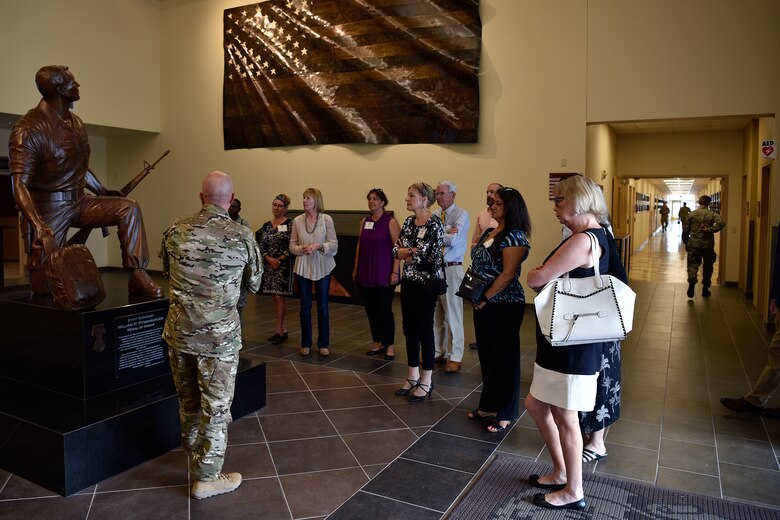 U.S. Air Force Master Sgt. Chris Trisko, 351st Special Warfare Training Squadron operations superintendent, talks to honorary commanders about the history of pararescue.