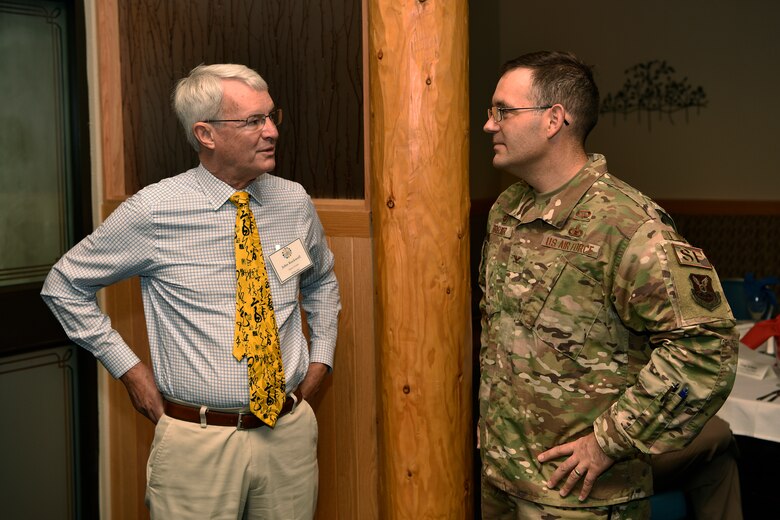 U.S. Air Force Col. Theodore Breuker, 377th Security Forces Group commander, talks with John Rockwell, 377th SFG honorary commander.