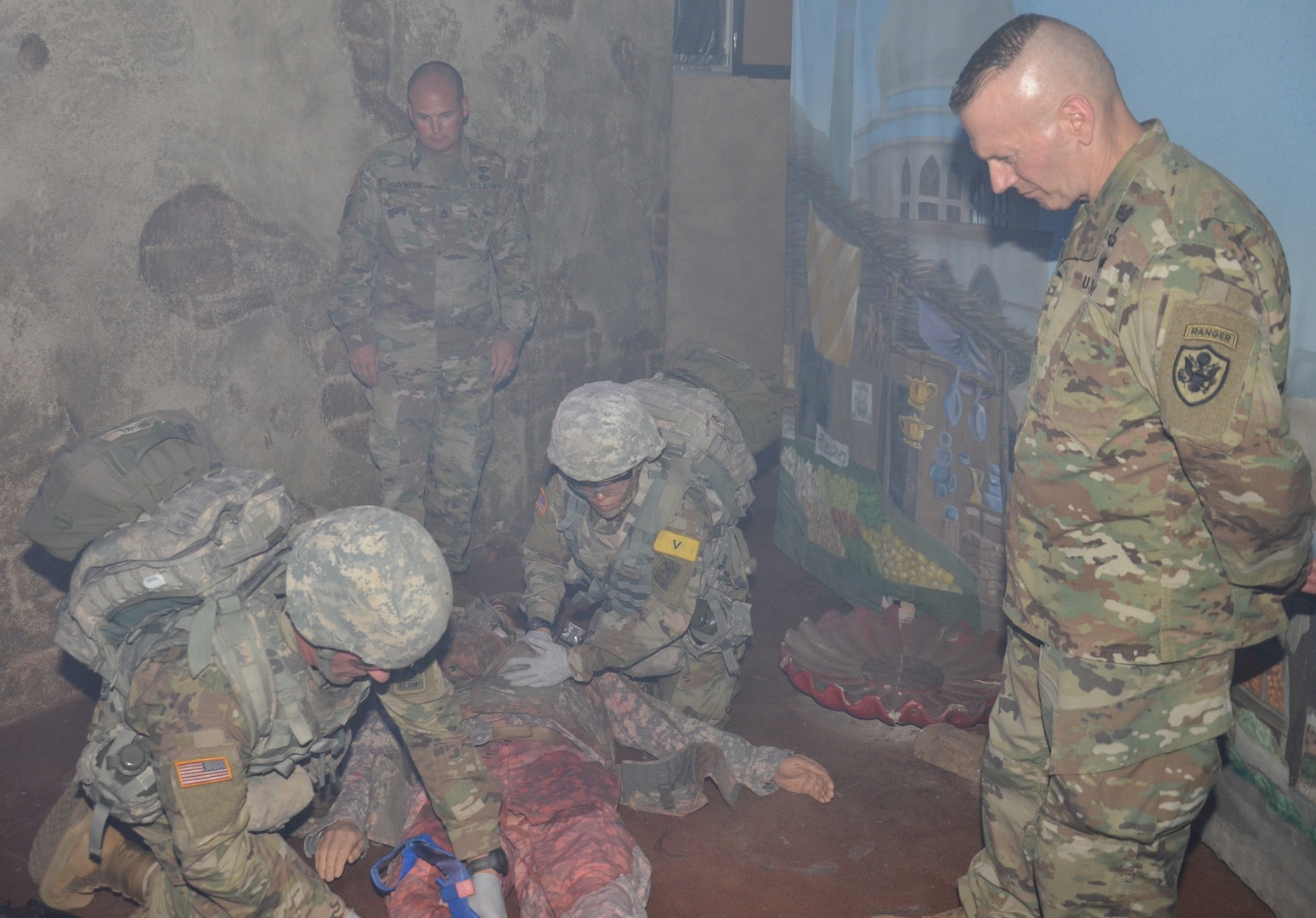 Command Sgt. Major John Wayne Troxell, senior enlisted advisor to the Chairman of the Joint Chiefs of Staff and the senior non-commissioned officer in the U.S. Armed Forces, observes Army Combat Medic Training trainees conduct an exercise in the Combat Trauma Patient Simulator constructed to resemble a Middle Eastern marketplace in the aftermath of an explosion set off by a suicide bomber. The “casualties,” which are life-like manikins called human patient simulators, appear to have received several traumatic injuries including amputations and gunshot wounds. The combat medic trainees assess the injuries and take actions to treat them while sirens blare, the room fills with smoke, and the lights are dimmed.