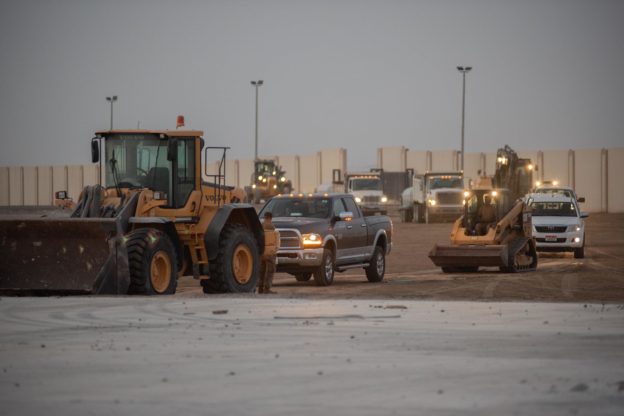 A convoy of civil engineers assigned to the 380th Expeditionary Civil Engineer Squadron arrive on site during a rapid airfield damage repair exercise July 26, 2019, at Al Dhafra Air Base, United Arab Emirates. RADR allows aircraft to start utilizing a previously damaged airfield in a matter of hours compared to days with traditional repair methods. (U.S. Air Force photo by Staff Sgt. Chris Thornbury)