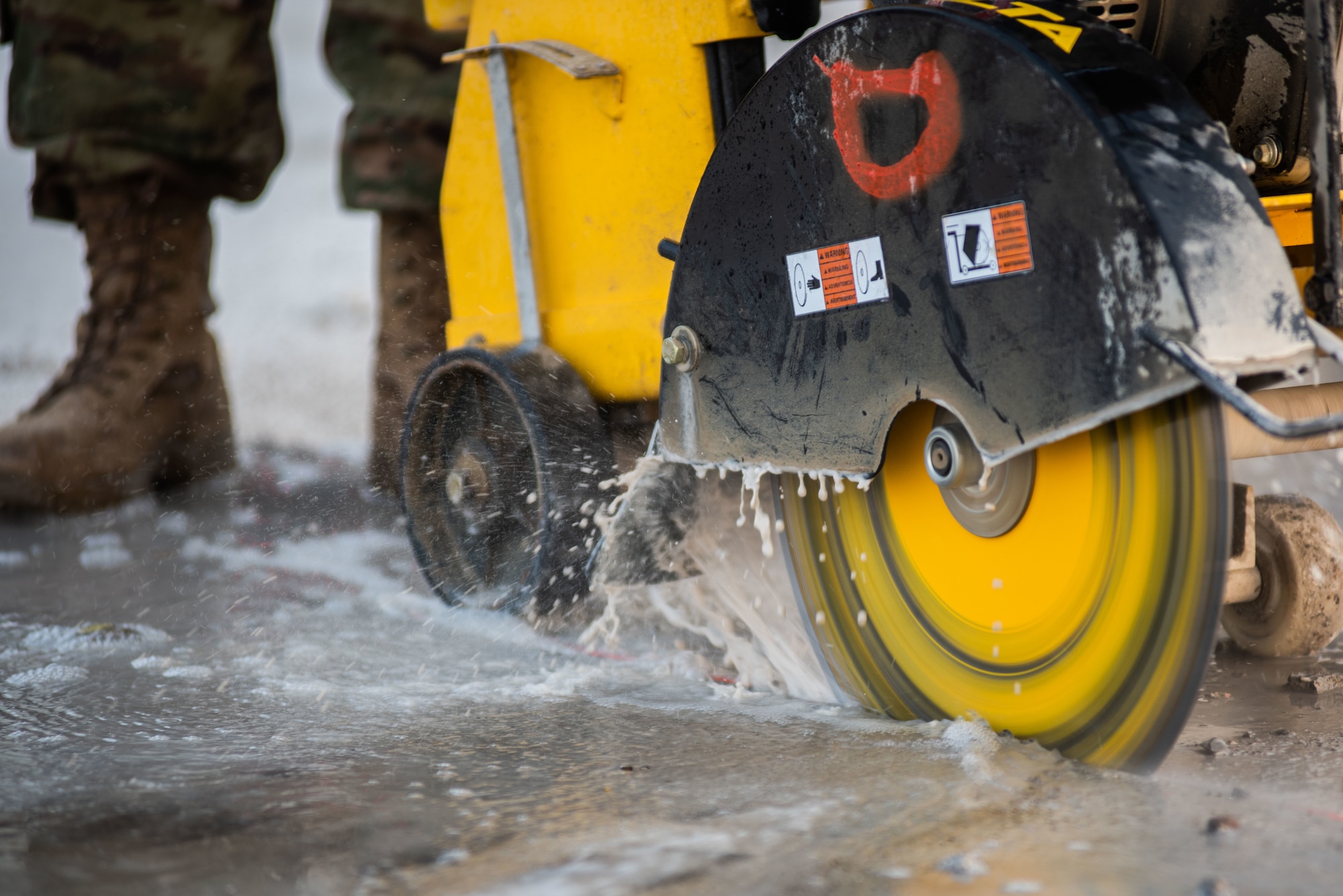 A 380th Expeditionary Civil Engineer Squadron water and fuels technician cuts concrete during a rapid airfield damage repair exercise July 26, 2019, at Al Dhafra Air Base, United Arab Emirates. By cutting the concrete it can be broken up and removed efficiently and later filled with fast-curing concrete. (U.S. Air Force photo by Staff Sgt. Chris Thornbury)