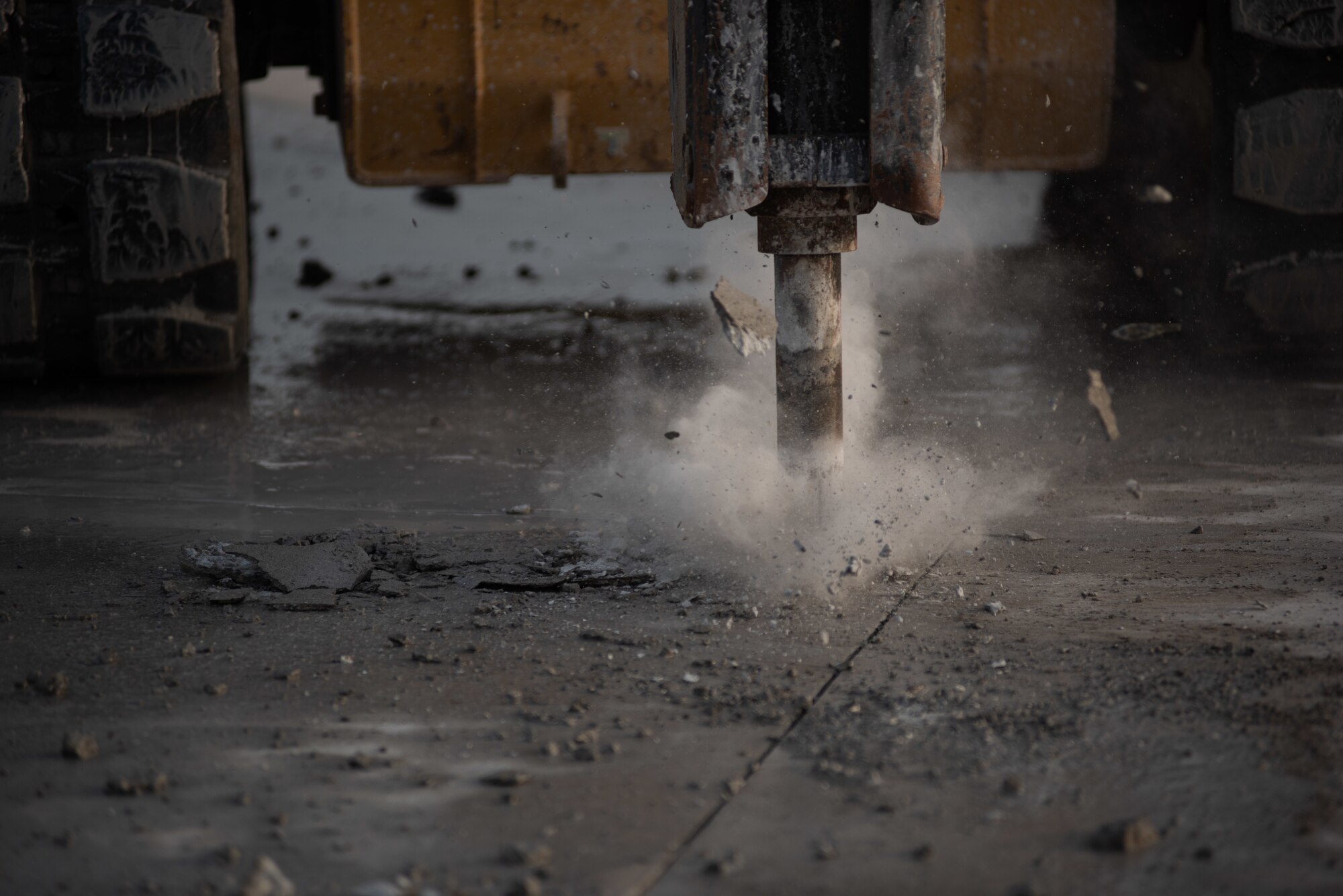 A compact track loader with a jackhammer attachment breaks concrete during a rapid airfield damage repair exercise July 26, 2019, at Al Dhafra Air Base, United Arab Emirates. After breaking the concrete apart, an excavator can remove the debris so the remaining hole can be filled with fast-curing concrete. (U.S. Air Force photo by Staff Sgt. Chris Thornbury)