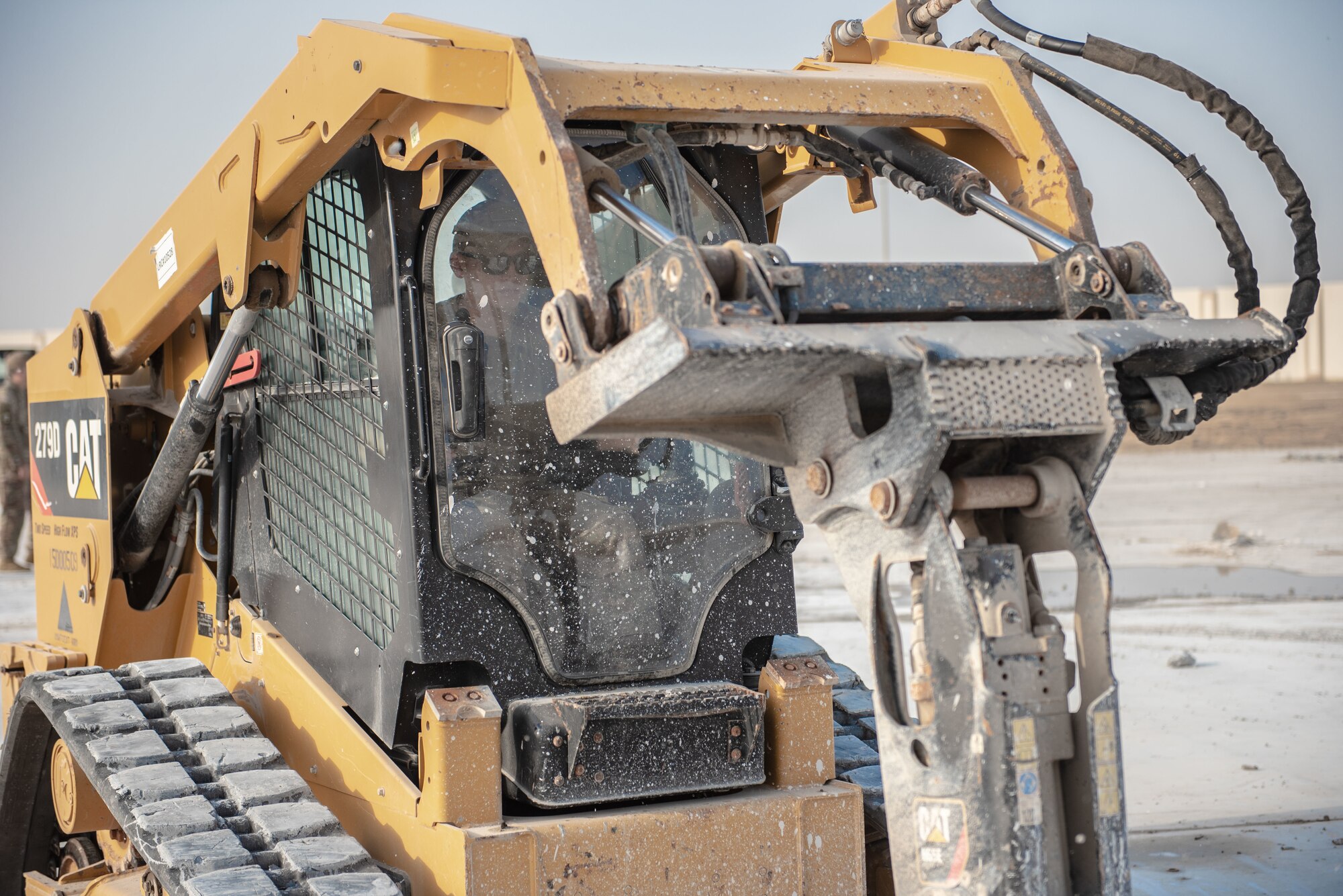 Airman 1st Class Louis Lamorgese, 380th Expeditionary Civil Engineer Squadron heavy machine operator, uses a compact track loader with a jackhammer attachment to break concrete during a rapid airfield damage repair exercise July 26, 2019, at Al Dhafra Air Base, United Arab Emirates. After breaking the concrete apart, an excavator can remove the debris allowing the remaining hole to be filled with fast-curing concrete. (U.S. Air Force photo by Staff Sgt. Chris Thornbury)