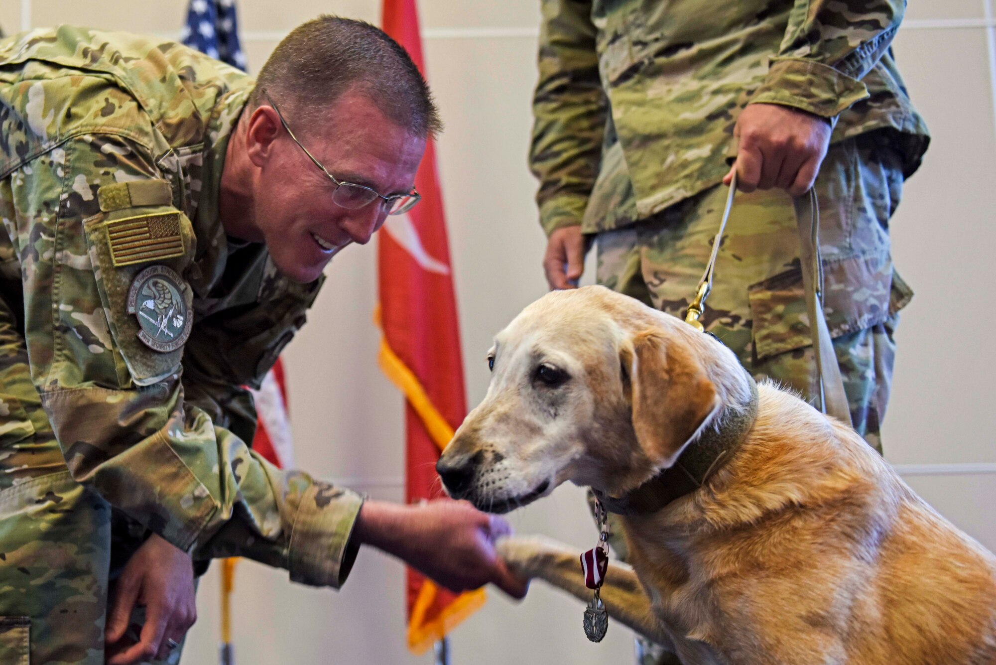U.S. Air Force Lt. Col. Kevin McMahon, 39th Security Forces Squadron commander, congratulates Autumn, a 39th SFS military working dog, during the latter’s retirement ceremony at Incirlik Air Base, Turkey, July 29, 2019. Autumn served seven years at Incirlik and earned the Meritorious Service Medal for her contributions to the mission. (U.S. Air Force photo by Staff Sgt. Joshua Magbanua)