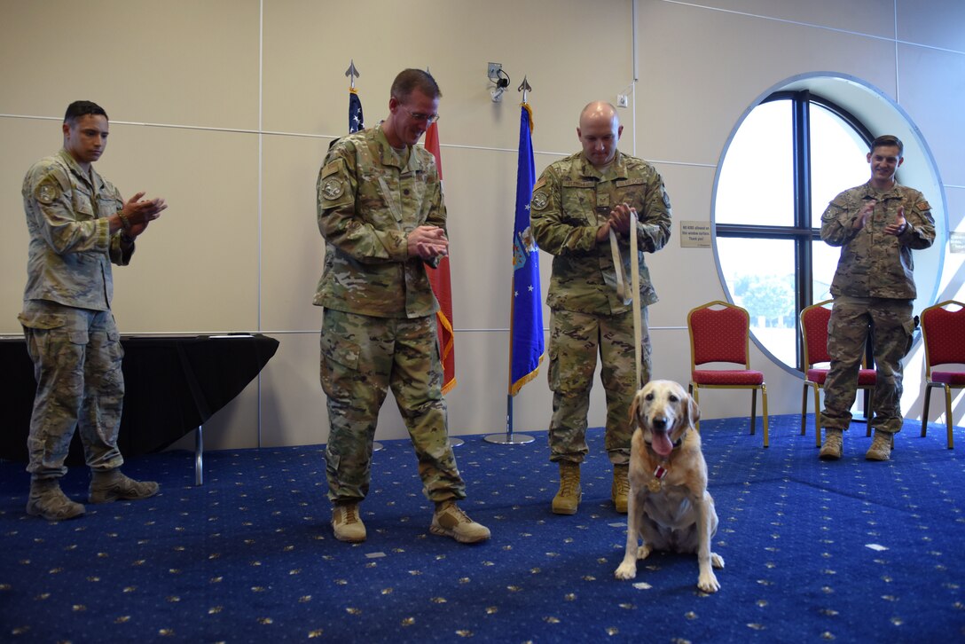 39th Security Forces Squadron Airmen congratulate Autumn, a military working dog, upon her retirement at Incirlik Air Base, Turkey, July 29, 2019. The practice of using utility dogs for warfare dates back thousands of years, as seen in evidence from the Ancient Romans and Egyptians. (U.S. Air Force photo by Staff Sgt. Joshua Magbanua)
