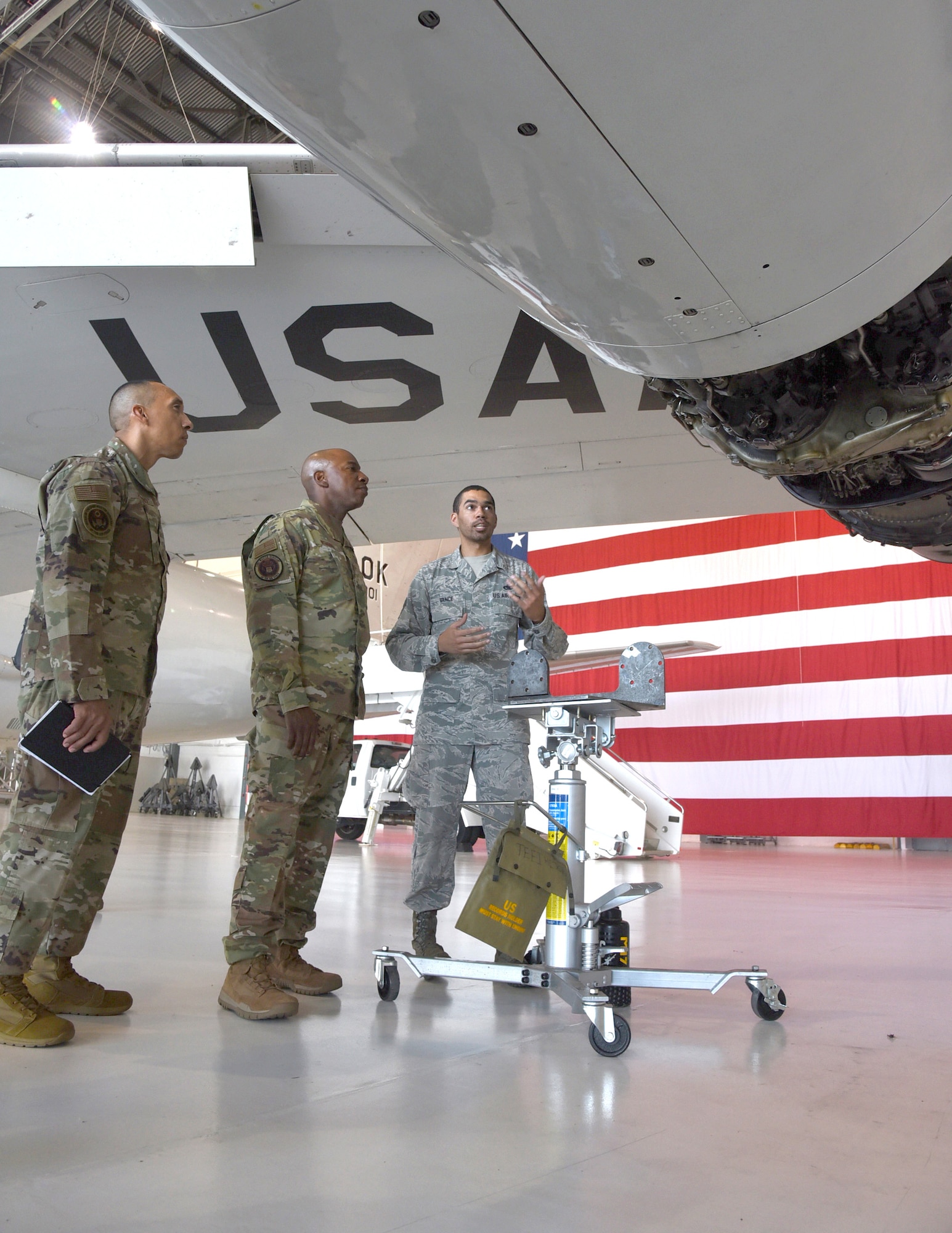 Chief Master Sgt. of the Air Force #18 Kaleth O. Wright visited several units at Tinker Air Force Base and toured the 137th Special Operations Wing at Will Rogers Air National Guard Base July 30-31. During his visit, Wright received an overview of Tinker missions with an emphasis on Airmen's contributions to readiness through innovation and their impact throughout the Air Force. Shown here, Staff Sgt. Kasey Vance, 552nd Maintenance Squadron, demonstrates improvements to an engine gearbox on an E-3 Sentry Airborne Warning and Control System aircraft. Wright also delivered a presentation focusing on Wingman and total force resiliency at an Enlisted All Call at Rose State College. (U.S. Air Force photo/Kelly White)