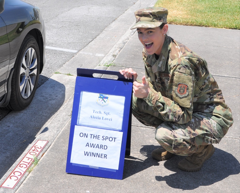 Tech. Sgt. Alecia Lovci, 340th Flying Training Group Undergraduate Flying Training program student administration specialist, claims her turn in the boss' parking slot following her selection as the July On-the-Spot Award winner. (U.S. Air Force photo by Janis El Shabazz)