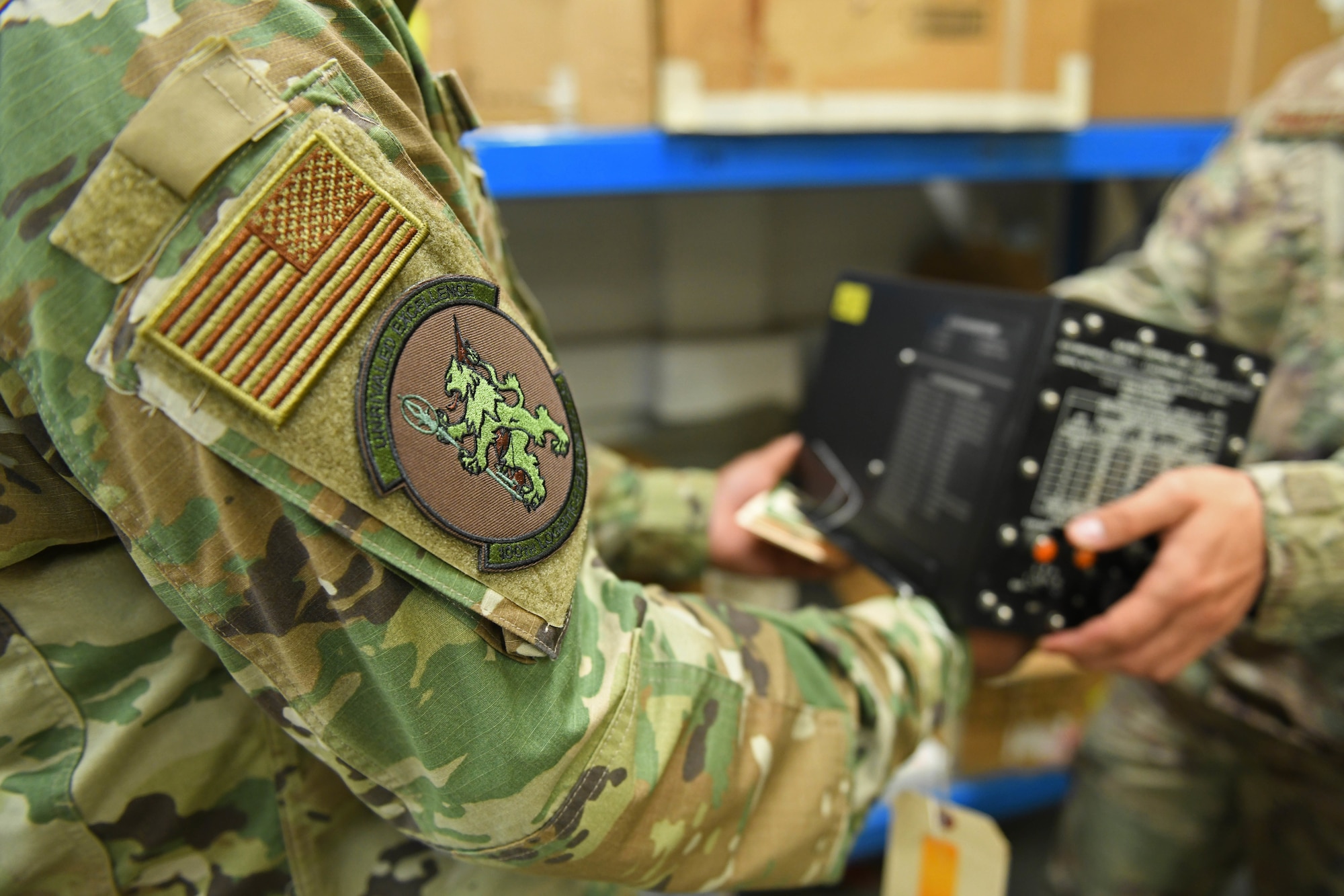 Staff Sgt. Jordan-Dean Morgan, 100th Logistics Readiness Squadron decentralized maintenance support supervisor, passes an aircraft part to an Airman from the 100th Aircraft Maintenance Squadron at RAF Mildenhall, England, July 31, 2019. The 100th DMS supports five different squadrons on RAF Mildenhall encompassing three different major commands. (U.S. Air Force photo by Senior Airman Luke Milano)