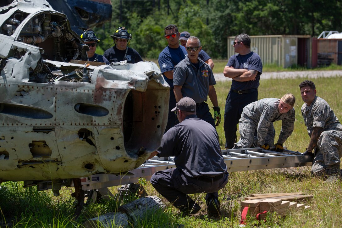 First Responders from multiple departments throughout South Carolina preform a lever technique on a downed aircraft aboard Marine Corps Air Station Beaufort, July 25. The lever technique is important for first responders because it doesn’t require many resources to accomplish, training as a team helps keep our interoperability between departments high. (U.S. Marine Corps photo by Lance Cpl. Aidan Parker)