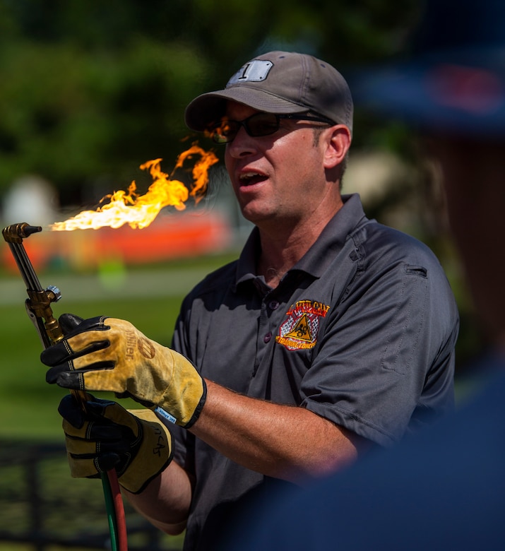 Deputy Chief Phil Higgins an instructor from P.L Vulcan Fire Training shows how to properly light and use a torch aboard Marine Corps Air Station Beaufort, July 25. P.L. Vulcan Fire Training is a team with combined over 40 years of experience in the fire and emergency services field who travel from Brooklyn, New York to teach different departments these lifesaving skills. (U.S. Marine Corps photo by Lance Cpl. Aidan Parker)