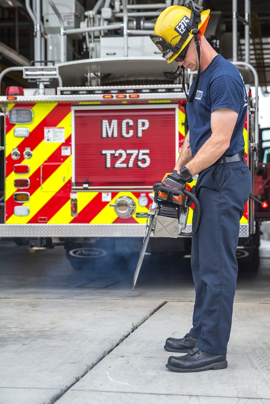 Jeremy Horton, a firefighter with the Marine Corps Base Camp Pendleton Fire Department, performs a function check on a chainsaw during the duty change over at MCB Camp Pendleton Fire Department Station Five on MCB Camp Pendleton, California, Aug. 1, 2019.  The MCB Camp Pendleton firefighters operate on 48-hour shifts, and spend the first morning of their shift assessing and cleaning vehicles and equipment to ensure mission readiness. The fire department has 11 stations on the installation and over 100 firefighters to act as first responders in the event of a fire or emergency.