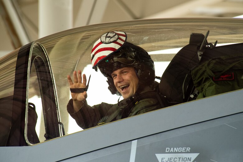 An F-35A Lightning II pilot with the 421st Fighter Squadron waves as he returns from a deployment to Hill Air Force Base, Utah, July 31, 2019. The 421st Fighter Squadron participated in several combat exercises with allied and partner nations while deployed to Europe. (U.S. Air Force photo by R. Nial Bradshaw)