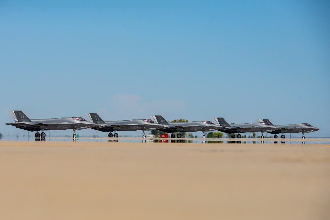 Five F-35A Lightning IIs line up before taking off