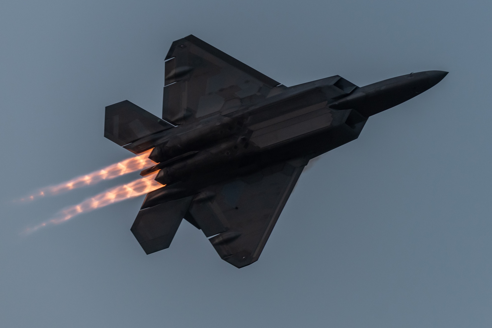 An F-22 flies a twilight demonstration