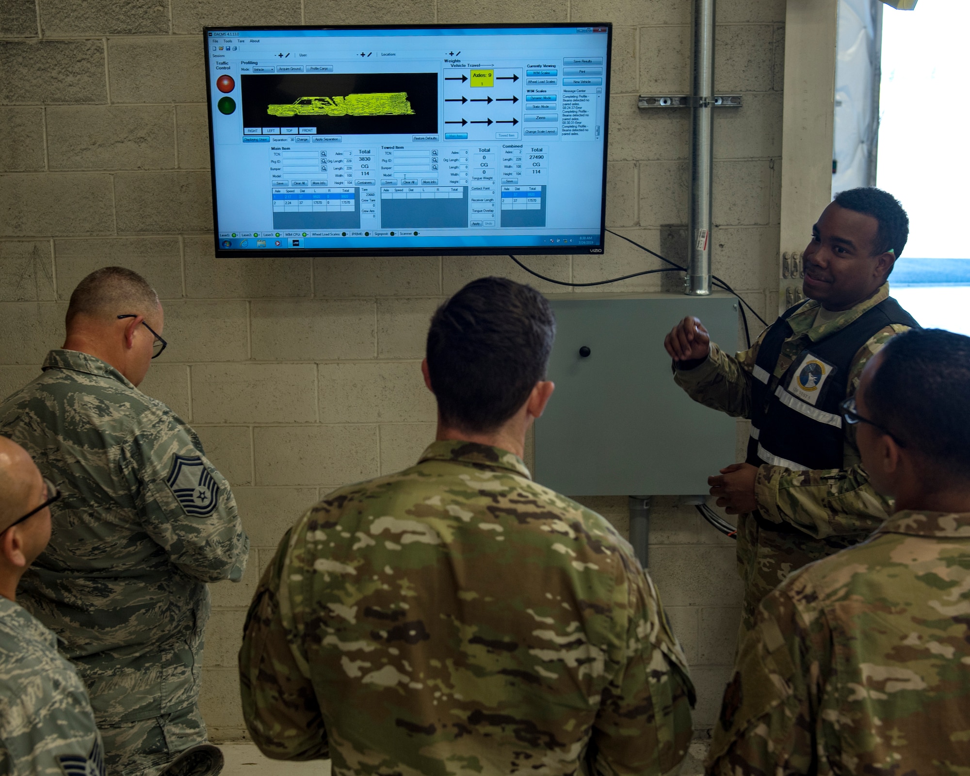 U.S. Air Force Senior Airman Jevon Butler, 92nd Logistics Readiness Squadron air transportation journeyman, explains the documentation from the weigh-in-motion scales during a Cargo Deployment Function exercise at Fairchild Air Force Base, Washington, July 24, 2019. The 92nd LRS partners with members from the 92nd Medical Group, 92nd Maintenance Group, 92nd Operations Group and 92nd Mission Support Group in continuous process improvement to refine the CDF line. (U.S. Air Force photo by Airman 1st Class Whitney Laine)