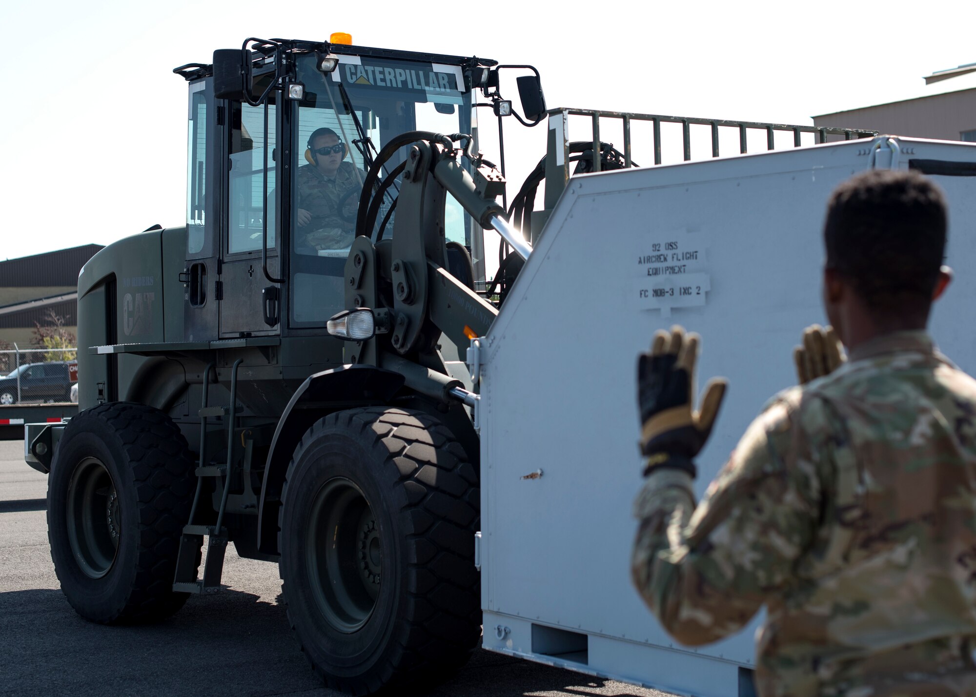 U.S. Air Force Senior Airman Dylan Oswalt, 92nd Logistics Readiness Squadron ground transportation journeymen, navigates cargo with a forklift during a Cargo Deployment Function exercise at Fairchild Air Force Base, Washington, July 24, 2019. Team Fairchild LRS Airmen practice quick cargo deployment often to execute air mobility support. (U.S. Air Force photo by Airman 1st Class Whitney Laine)