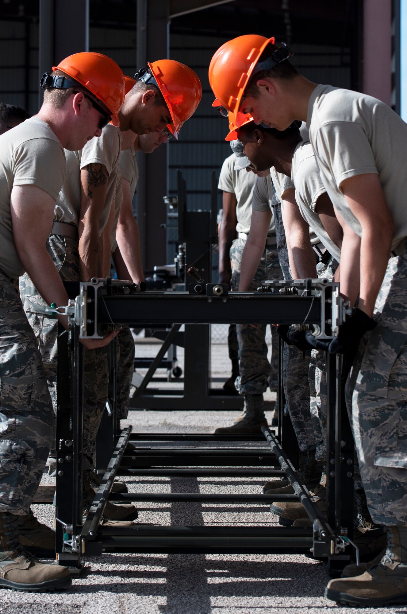 363rd Training Squadron munitions apprentice course students carry a munitions assembly conveyor at Sheppard Air Force Base, Texas, August 1, 2019. The students learn how to assemble a MAC and connect multiple MACs together to create a longer conveyor. They use these MACs to create assembly lines for bomb production and can be assembled in almost any area. (U.S. Air Force photo by Air Force photo by Airman 1st Class Pedro Tenorio)