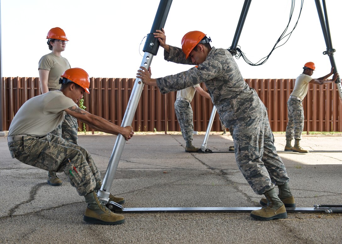 363rd Training Squadron munitions apprentice course students piece together a munitions assembly conveyor at Sheppard Air Force Base, Texas, August 1, 2019. The MAC can be assembled anywhere and is used during deployments to quickly build munitions. The MAC's speed and effectiveness is key to mission success during wartime operations. (U.S. Air Force photo by Senior Airman Ilyana A. Escalona)
