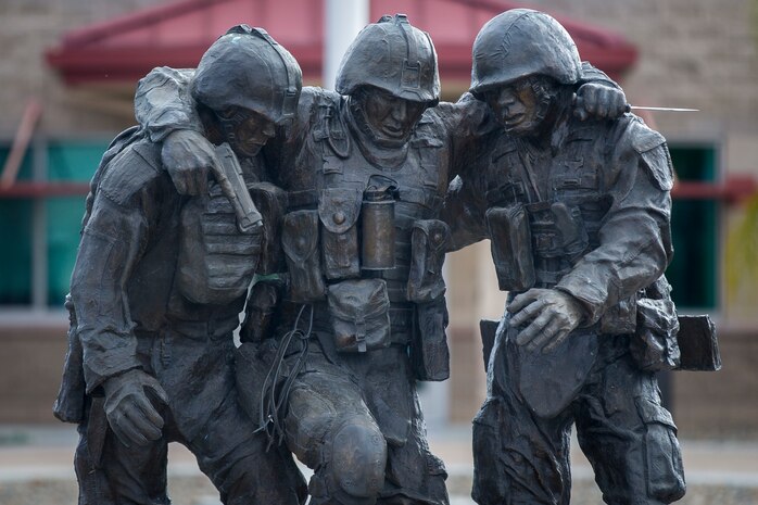 The commemorative statue of 1st Sgt. Bradley Kasal being carried by Lance Cpl. Chris Marquez and Lance Cpl. Dan Shaffer, after taking heavy fire, stands outside of the Wounded Warrior Battalion-West headquarters building on Marine Corps Base Camp Pendleton, Calif., June 1, 2018.  WWBn-W is committed to the successful recovery and transition of each Marine and family assigned to its care, and focuses on the mind, body and spirit of every individual when addressing recovery needs. (U.S. Marine Corps Cpl. Juan C. Bustos)