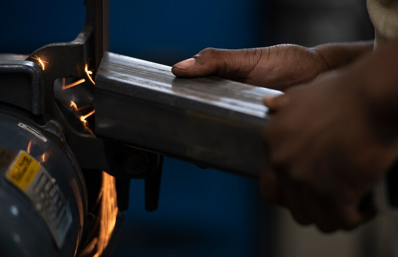 U.S. Air Force Airman 1st Class Tylique McMichael, 20th Equipment Maintenance Squadron aircraft metals technology apprentice, grinds a piece of metal at Shaw Air Force Base, South Carolina, July 30, 2019.