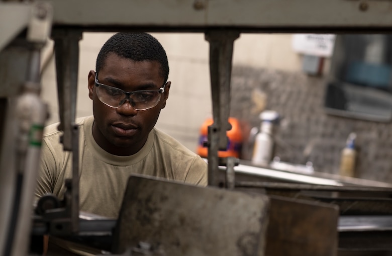 U.S. Air Force Airman 1st Class Tylique McMichael, 20th Equipment Maintenance Squadron aircraft metals technology apprentice, works on a piece of metal at Shaw Air Force Base, South Carolina, July 30, 2019.