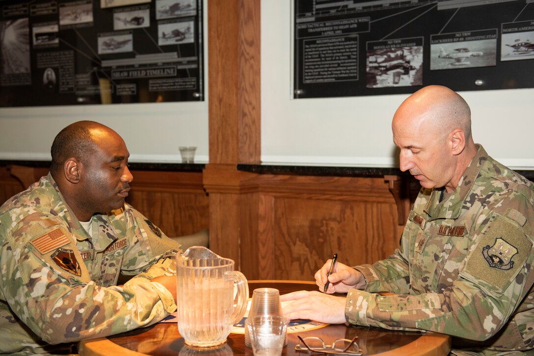 Chief Master Sgt. John Kirby, U.S. Air Forces Central Command (AFCENT) A3 aircraft control function manager, right, advises Master Sgt. Ernest Wheeler, U.S. AFCENT A6XR, section chief on his Enlisted Program Report (EPR) during a speed mentoring session at the 20th Force Support Squadron Carolina Skies Club, Shaw Air Force Base, South Carolina, July 30, 2019.