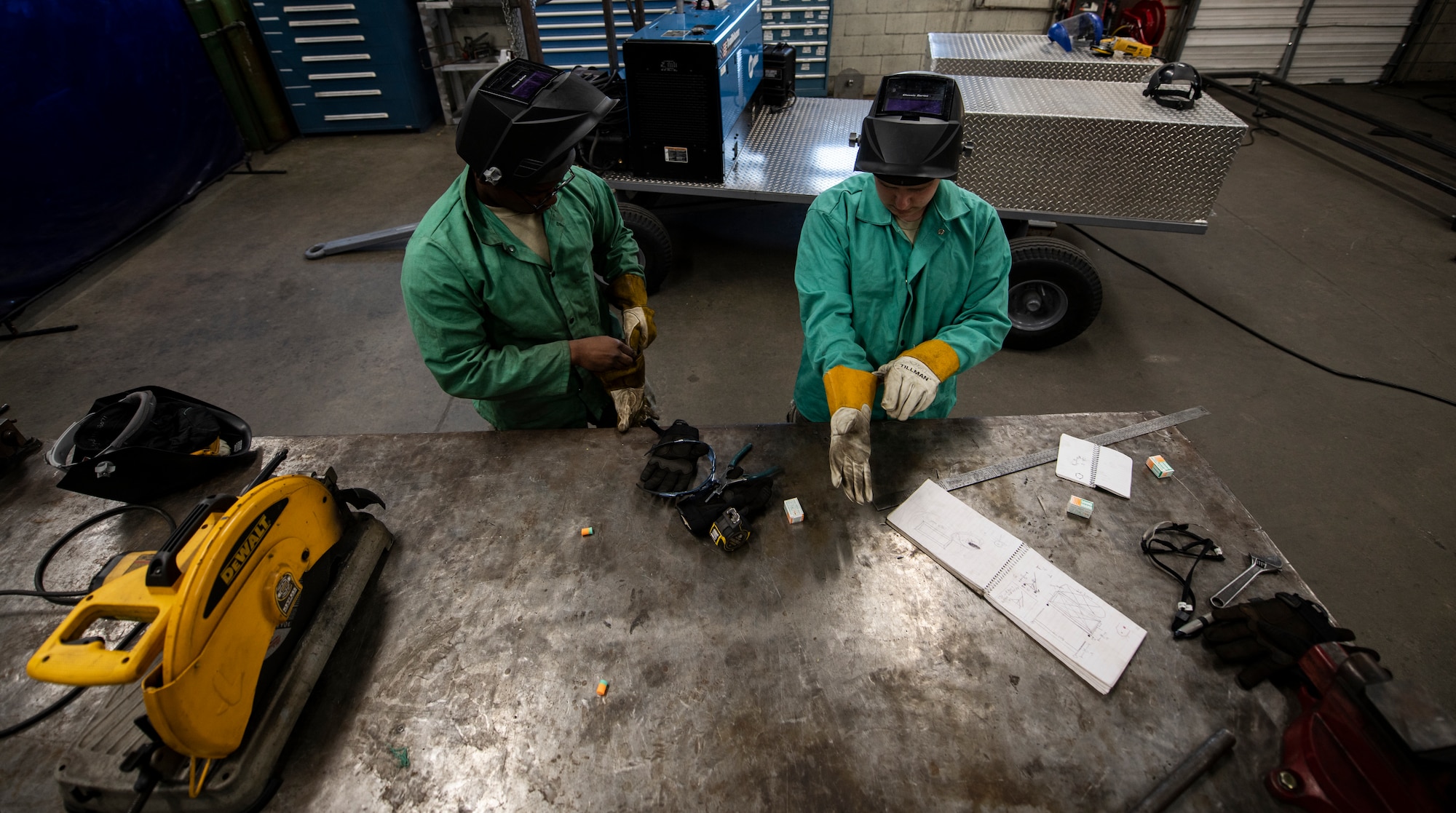 From left, U.S. Air Force Airmen 1st Class Tylique McMichael and Dakota Montgomery, 20th Equipment Maintenance Squadron aircraft metal technology apprentices, gear up prior to using a plasma cutter at Shaw Air Force Base, South Carolina, July 30, 2019.