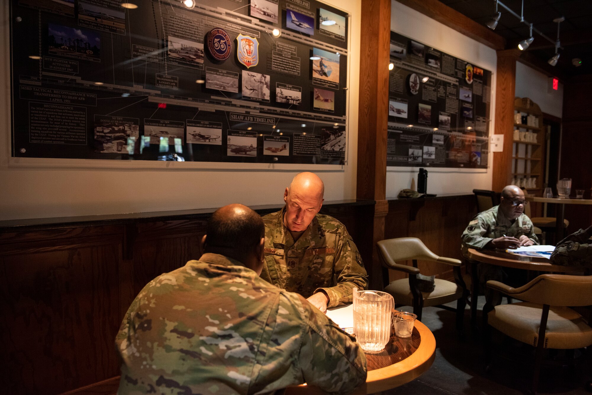 Chief Master Sgt. John Kirby, U.S. Air Forces Central Command  (AFCENT) A3 aircraft control function manager, center, provides mentoring tips to advises Master Sgt. Ernest Wheeler, U.S. AFCENT A6XR, section chief, during a speed mentoring program at the 20th Force Support Squadron Carolina Skies Club, Shaw Air Force Base, South Carolina, July 30, 2019.
