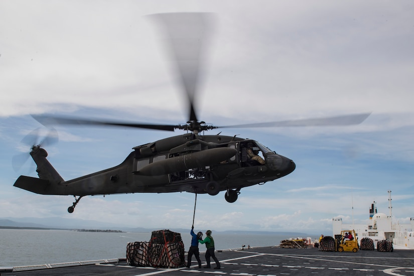 U.S. Navy sailors aboard the U.S.N.S. Comfort attach a load of medical equipment and supplies to a UH-60 Balckhawk to be transported to Punta Arenas, Costa Rica, July 21, 2019. Pilots and aircrew assigned to the 1st Battalion, 228th Aviation transported personnel and equipment to allow the U.S. Naval Ship Comfort to provide medical care to Costa Rican citizens and Venezuelan migrants as part of the United States enduring promise of helping its southern neighbors. The Winged Warriors transported more than 470 people and 20 tons of cargo from July 21 - 30. (U.S. Air Force photo by Staff Sgt. Eric Summers Jr.)