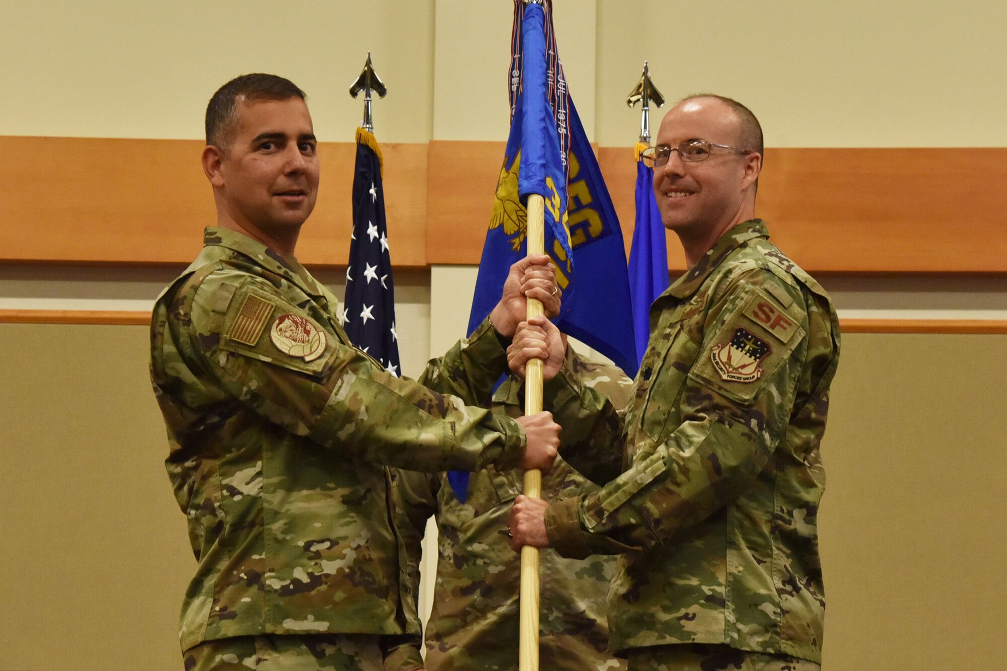 Lt. Col. Joseph Merrill, right, accepts command of the 341st Missile Security Forces Squadron from Col. Frank Reyes, 341st Security Forces Group commander during a change of command ceremony August 2, 2019, at Malmstrom Air Force Base, Mont.