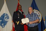 Thomas Smith, right, part of the Defense Logistics Agency Troop Support’s Industrial Hardware supply chain, received the Superior Civilian Service Award from Army Brig. Gen. Gavin Lawrence, DLA Troop Support commander on July 30, 2019 during a quarterly awards ceremony in Philadelphia. Smith received the award for serving as the liaison officer to the Combined Joint Force operations for DLA Support Team-Kuwait. Photo by Ed Moldonado.