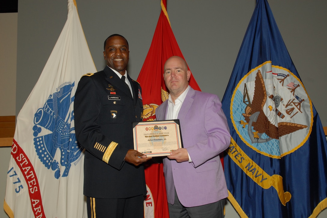John Finchen Jr., right, was named the Defense Logistics Agency Troop Support Employee of the Year for 2018. Finchen, who works in the agency’s Construction and Equipment supply chain, received his award from Army Brig. Gen. Gavin Lawrence, DLA Troop Support commander, during a quarterly awards ceremony on July 30, 2019 in Philadelphia. Photo by Ed Moldonado.