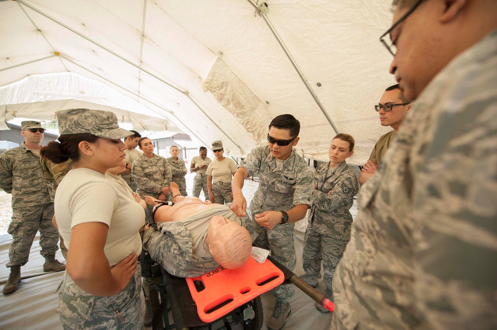 Maj. David Le, a flight surgeon, assigned to the 149th Medical Group, Air National Guard, goes over some best practices of trauma care before the start of an exercise at Coast Guard Station Lake Tahoe, Nevada, June 16, 2019.