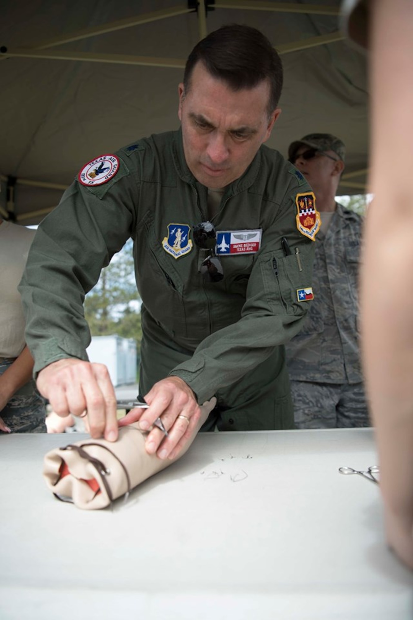 Lt. Col. Charles Biediger, a flight surgeon, assigned to the 149th Medical Group, Air National Guard, demonstrates the proper technique to suture a patient during a training exercise at Coast Guard Station Lake Tahoe, Nevada, June 16, 2019.