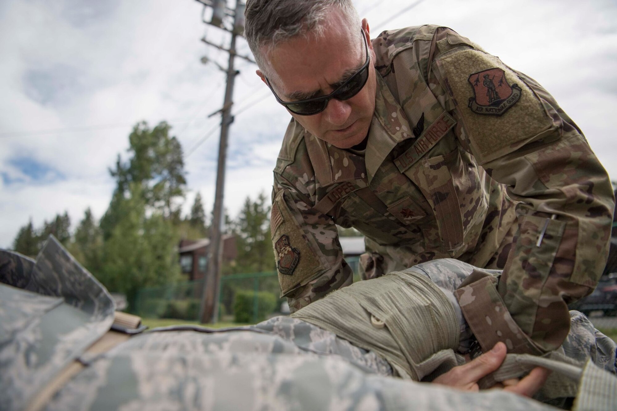 Maj. Christopher Lopes, a physicians assistant assigned to the 149th Medical Group, applies a combat bandage during Tactical Combat Casualty Care training at Coast Guard Station Lake Tahoe, Nevada, June 16.