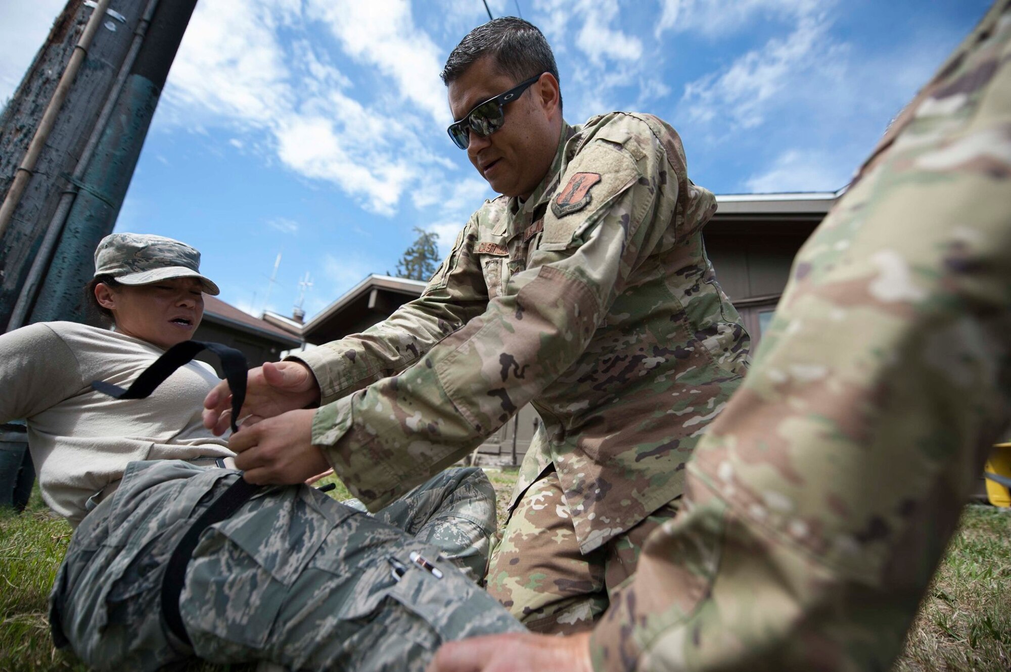 Tech. Sgt. John Castillo applies a tourniquet to Staff Sgt. Kimberly Gaona, both Serch and extraction medics assigned to 149th Medical Group, during Tactical Combat Casualty Care training at Coast Guard Station Lake Tahoe, Nevada, June 16.