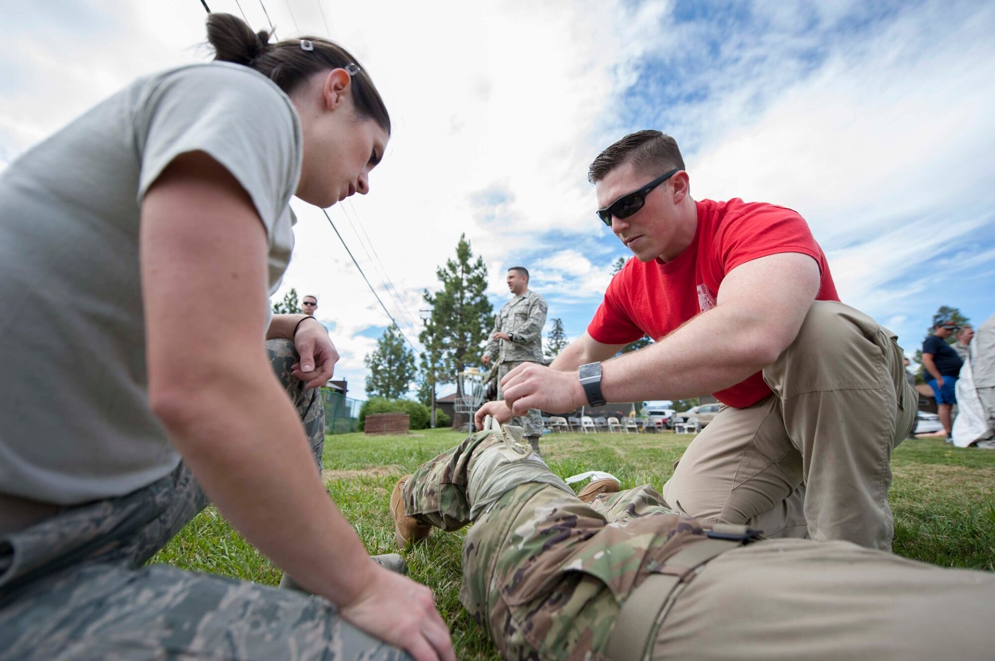 Staff Sgt Alisha Ayon, a medical technician assigned to the 149th Medical Group, receives an evaluation of her skills applying a combat bandage by Senior Airman Josh Adams a, medical technician assigned to the 152nd Medical Group, during Tactical Combat Casualty Care training at Coast Guard Station Lake Tahoe, Nevada, June 16.