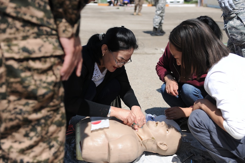 A participant in the trauma and mass casualty response training exercise practices providing emergency care on a medical mannequin, supervised by Mongolian Armed Forces and U.S. Air Force medical personnel in Bayongol Soum, Mongolia, July 26, 2019.