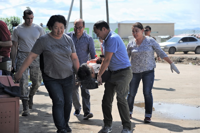 U.S. Air Force Maj. Zachary Gibson, 673rd Medical Operations Squadron emergency physician, oversees participants taking part in the trauma and mass casualty response training exercise in Bayongol Soum, Mongolia, July 26, 2019.