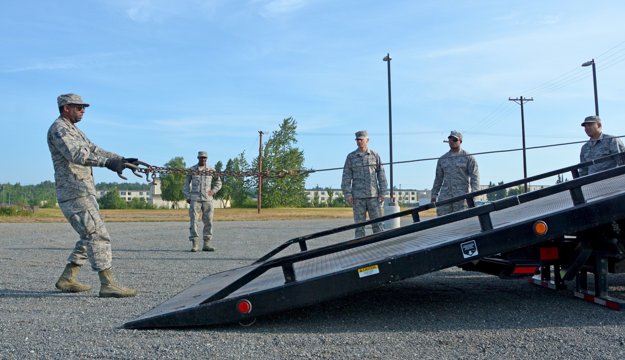 Tech. Sgt. Rahsaan Truett, 507th Logistics Readiness Squadron Ground Transportation Operations Center NCOIC, pulls out a tow chain on a rollback wrecker July 18, 2019, at Joint Base Elmendorf-Richardson, Alaska. (U.S. Air Force photo by Tech. Sgt. Samantha Mathison)