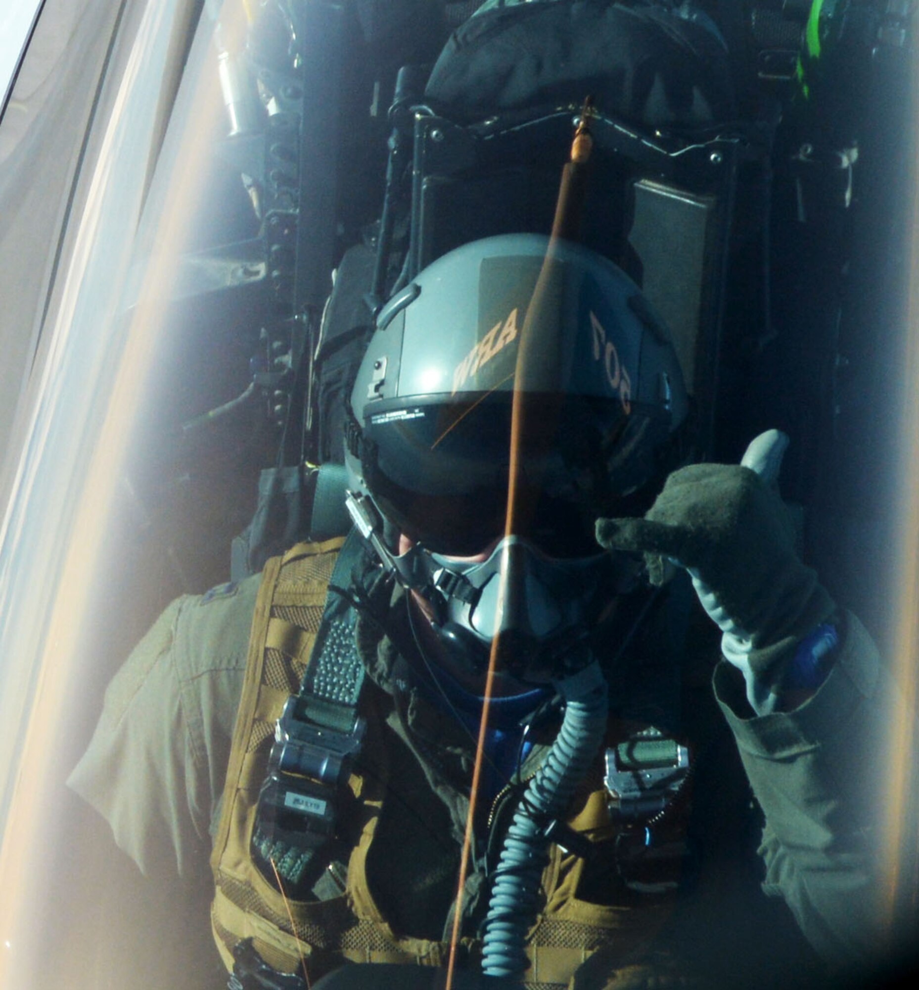 An F-22 Raptor pilot out of Joint Base Elmendorf-Richardson, Alaska, signals the boom operator after receiving fuel from a 507th Air Refueling Wing KC-135R Stratotanker July 19, 2019. (U.S. Air Force photo by Tech. Sgt. Samantha Mathison)