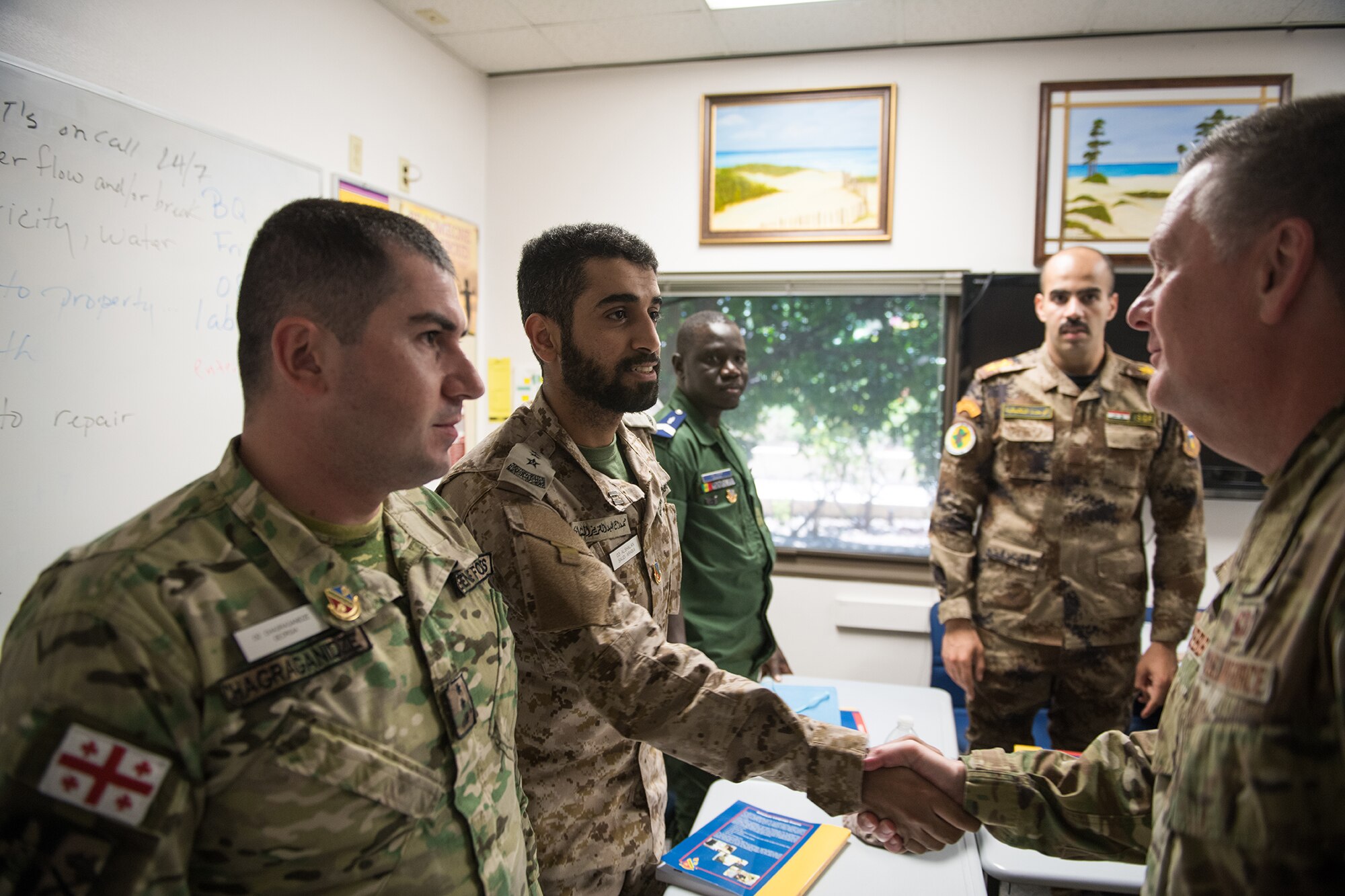 U.S. Air Force Lt. Gen. Brad Webb (right), commander of Air Education and Training Command (AETC), shakes hands with international students during his immersion tour at the 637th Training Group at Defense Language Institute English Language Center Aug. 1, 2019, at Joint Base San Antonio-Lackland, Texas.