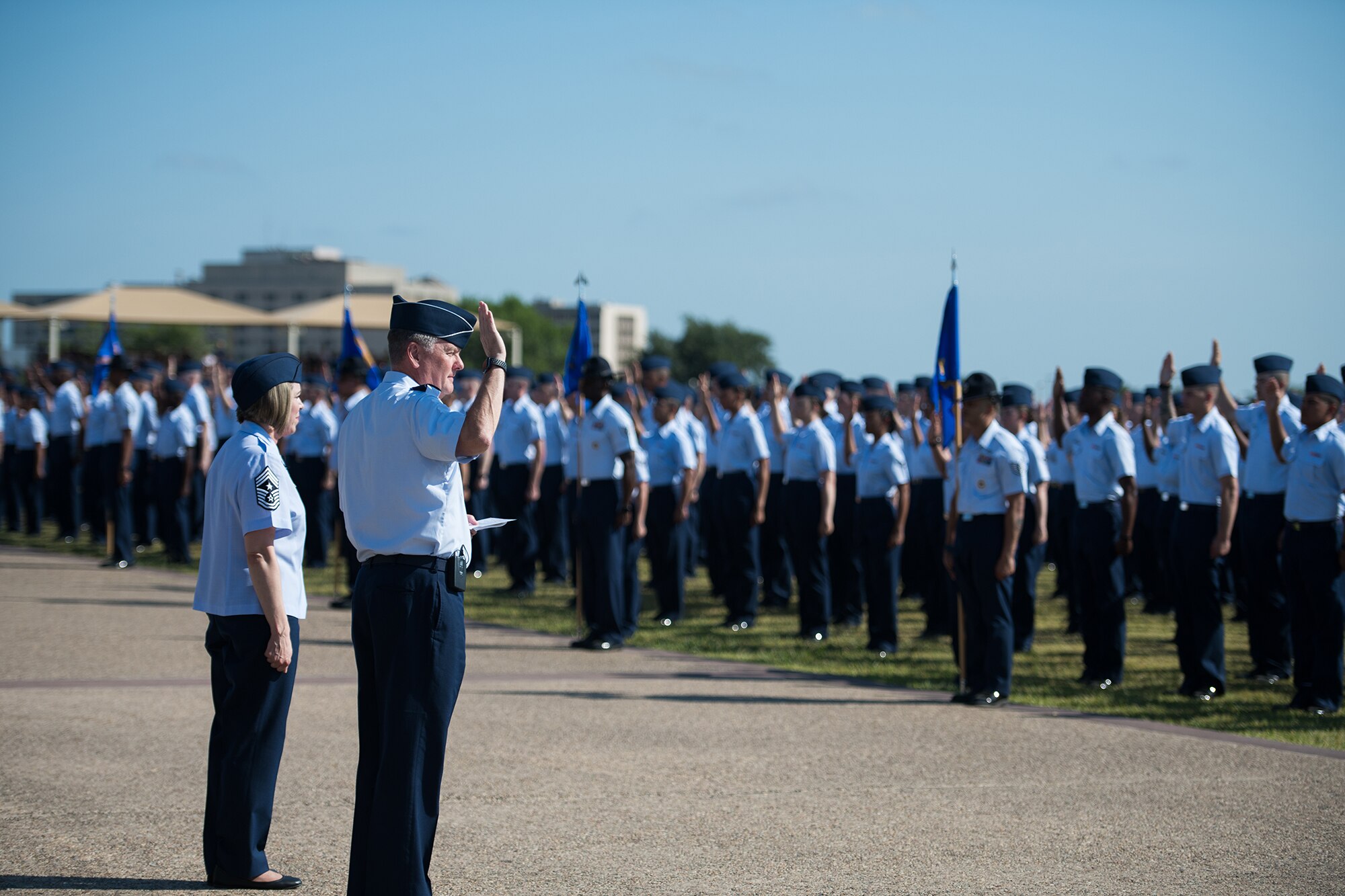U.S. Air Force Lt. Gen. Brad Webb (right), commander of Air Education and Training Command (AETC), gives the oath of enlistment to graduating Airmen Aug. 2, 2019, at Joint Base San Antonio-Lackland, Texas.